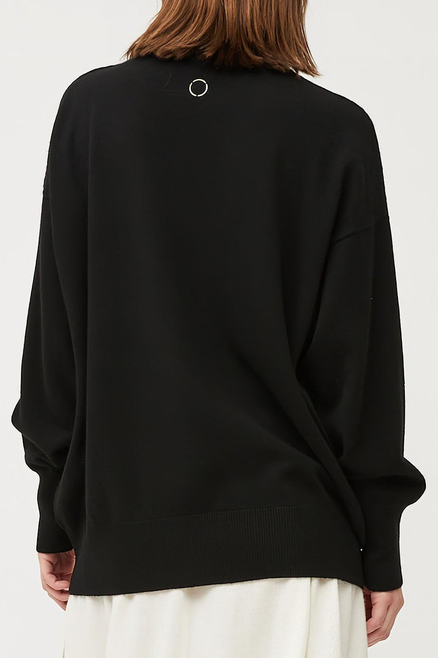 This image features the Kotto Sweater, highlighting its high-neck design and snug, comfortable fit. The sweater is presented in a classic, versatile black color, which enhances its elegant and timeless appeal.