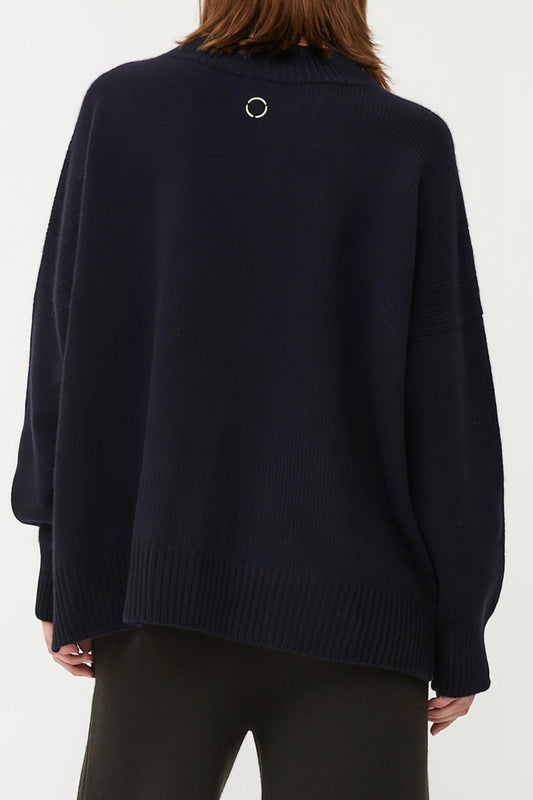 This image features the Aila Sweater, a stylish and versatile garment displayed on a model. The sweater is crafted in a chunky jersey stitch, offering a cozy and comfortable fit.