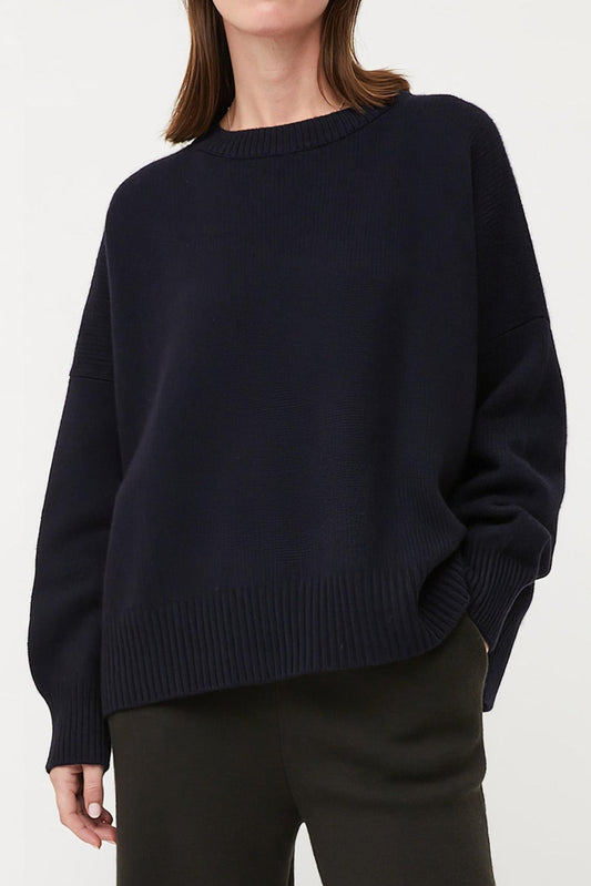 This image features the Aila Sweater, a stylish and versatile garment displayed on a model. The sweater is crafted in a chunky jersey stitch, offering a cozy and comfortable fit.