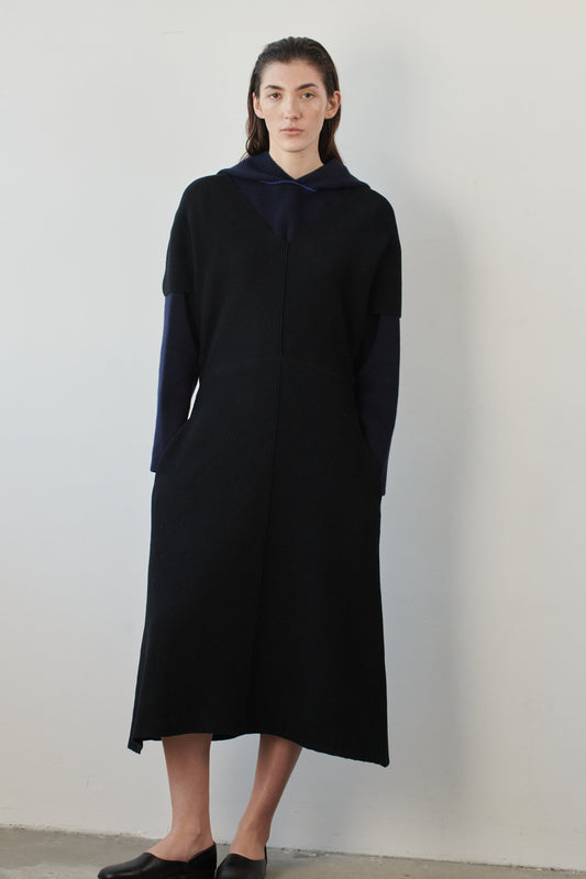 This image features a luxurious ocean & wave cashmere hoodie, modeled by a female. The hoodie boasts a modern and minimalist design, with a relaxed fit that enhances its appeal.