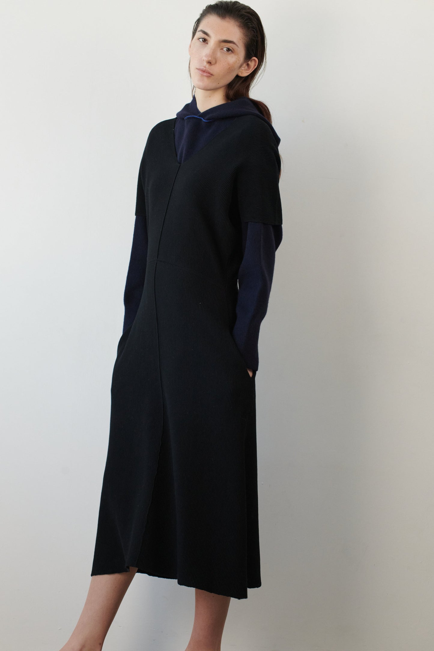 This image features a luxurious ocean & wave cashmere hoodie, modeled by a female. The hoodie boasts a modern and minimalist design, with a relaxed fit that enhances its appeal.