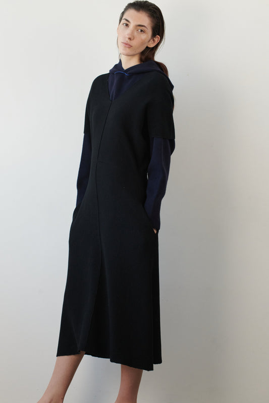 This image features a luxurious ocean & wave cashmere hoodie, modeled by a female. The hoodie boasts a modern and minimalist design, with a relaxed fit that enhances its appeal.