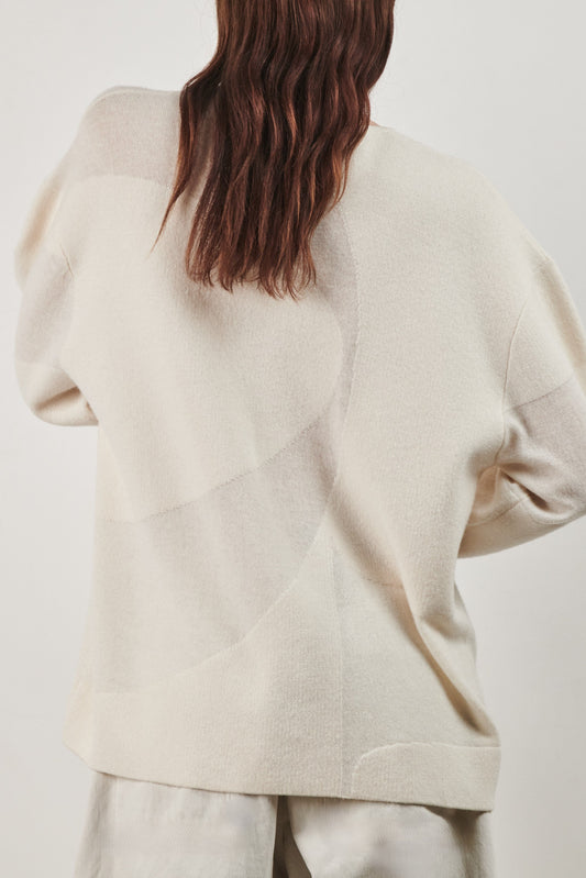 This image features the Arouc Sweater, a stylish and cozy garment ideal for everyday wear. The sweater displays a boxy silhouette and is crafted from a knitted jacquard fabric, presenting a subtle yet sophisticated pattern.