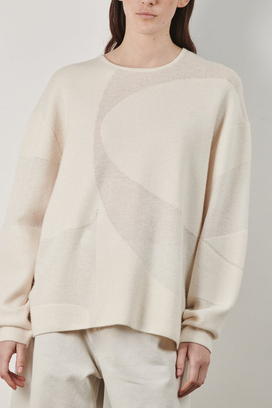 This image features the Arouc Sweater, a stylish and cozy garment ideal for everyday wear. The sweater displays a boxy silhouette and is crafted from a knitted jacquard fabric, presenting a subtle yet sophisticated pattern.