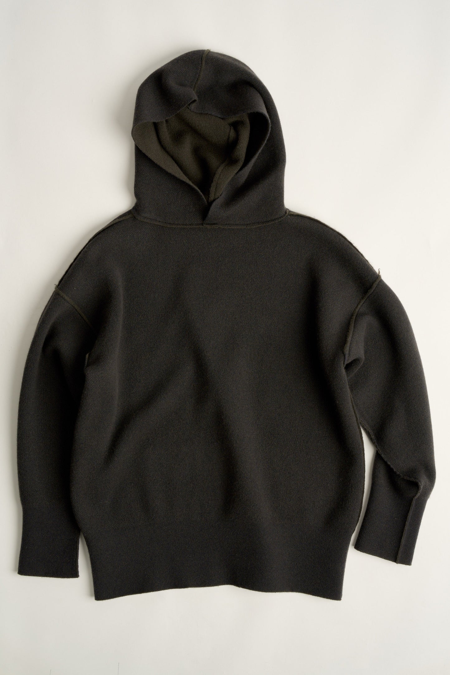 This image features a luxurious forest cashmere hoodie, modeled by a female. The hoodie boasts a modern and minimalist design, with a relaxed fit that enhances its appeal.