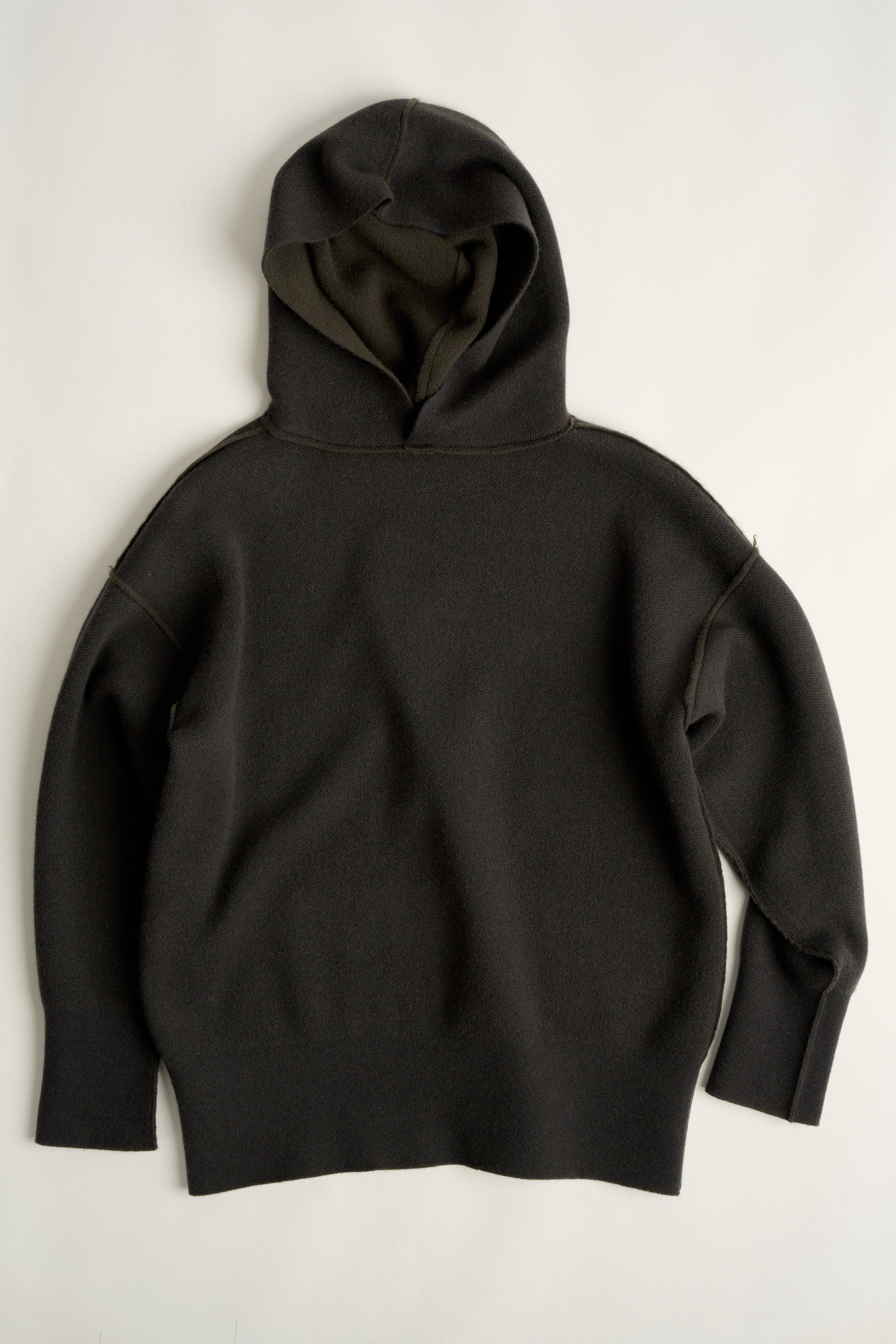 This image features a luxurious forest cashmere hoodie, modeled by a female. The hoodie boasts a modern and minimalist design, with a relaxed fit that enhances its appeal.